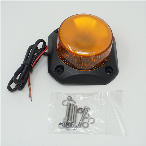 Amber warning light with wiring and screws on a white background